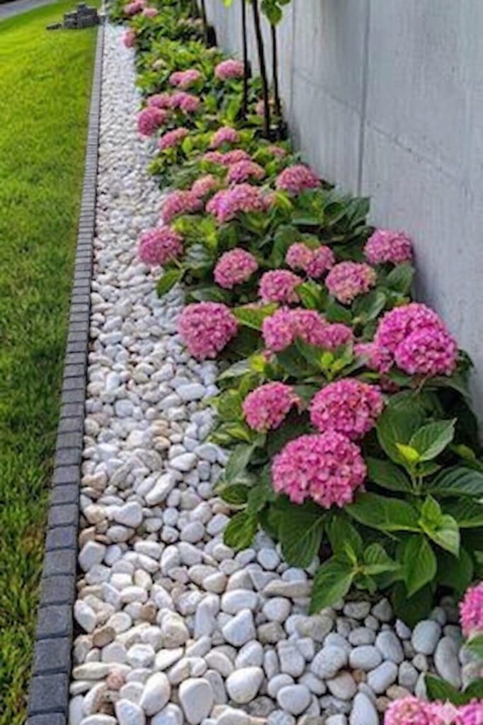 small garden with brick border separating plants from green lawn, simple and budget-friendly landscaping design